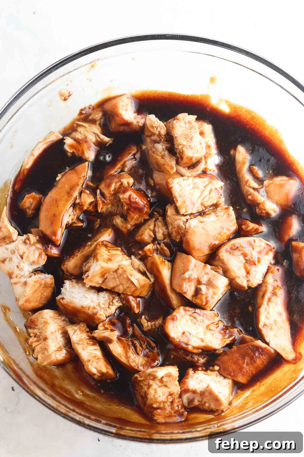 Marinate chicken in a large glass bowl.