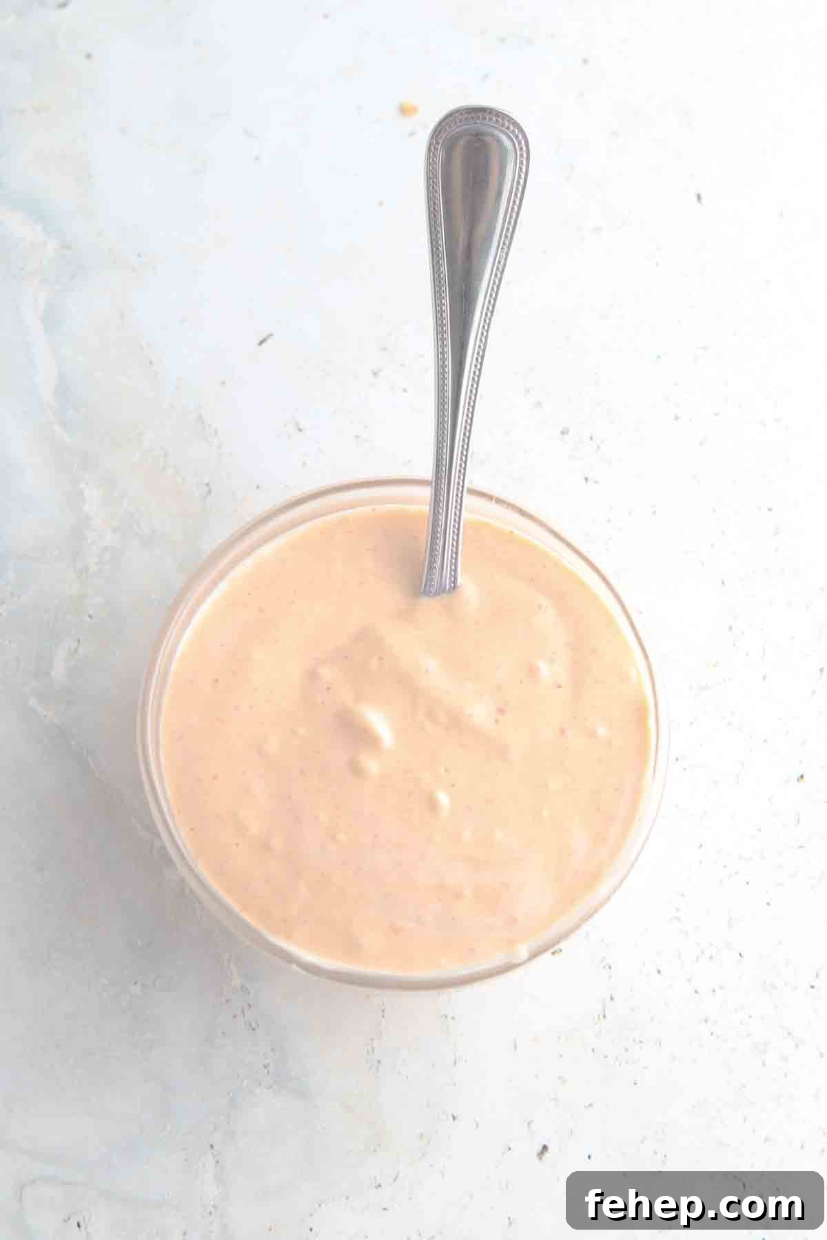 Spicy mayo ingredients in a small glass bowl.