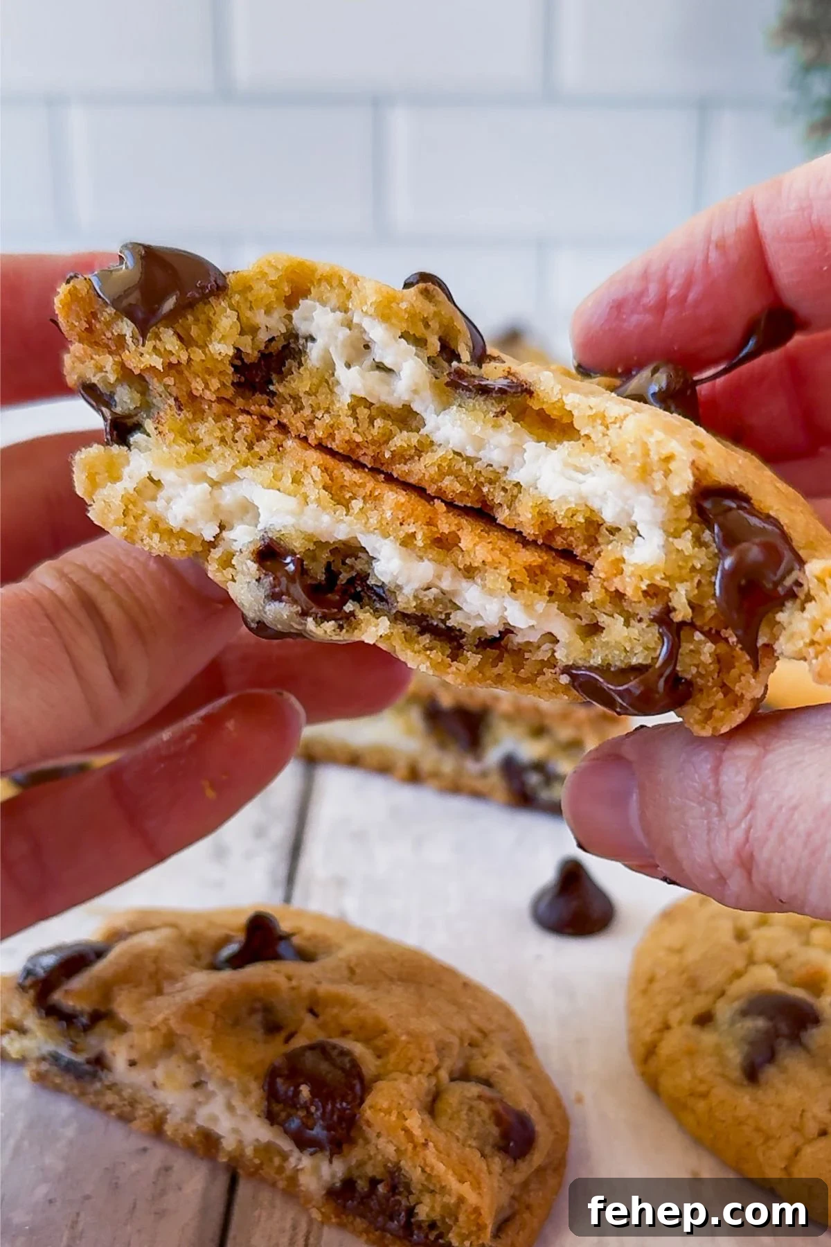 Chocolate chip cheesecake cookie in half.
