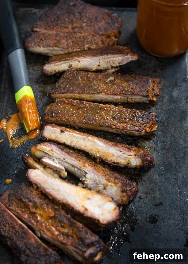 No Sugar Added Smoked Pork Ribs (Keto and Paleo Friendly)  sliced up on a serving platter