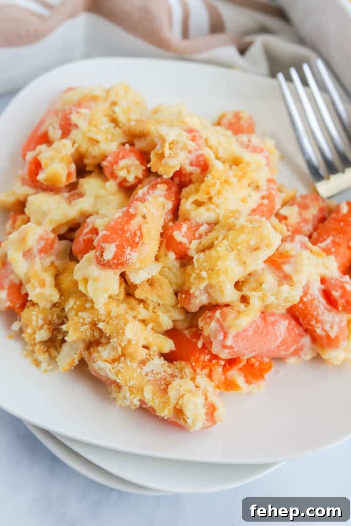 closeup of baked carrot casserole on stacked white plates.