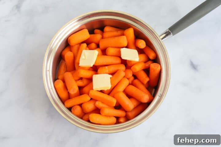 carrots in pan with butter ready to cook.