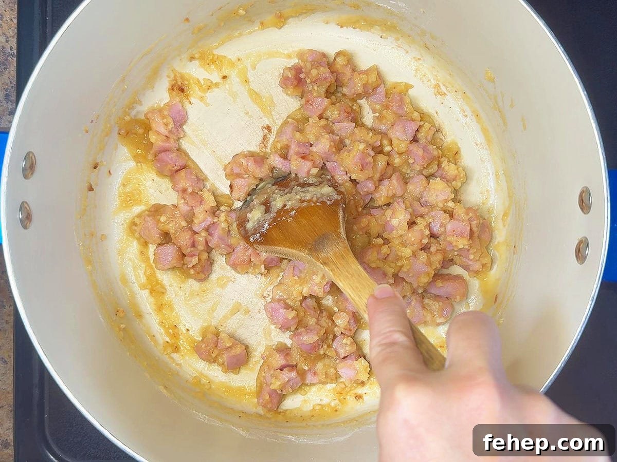Stirring garlic and flour into the cooked and diced ham.
