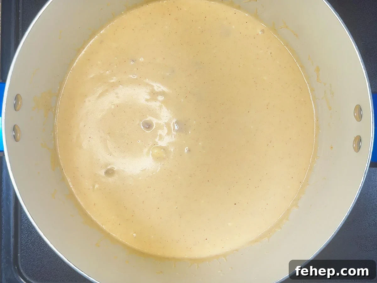 Sauce after the cream cheese, cheddar cheese, and garlic have been added.