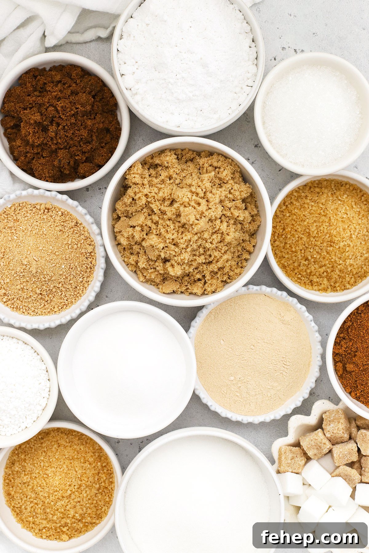 different kinds of sugar in small white bowls