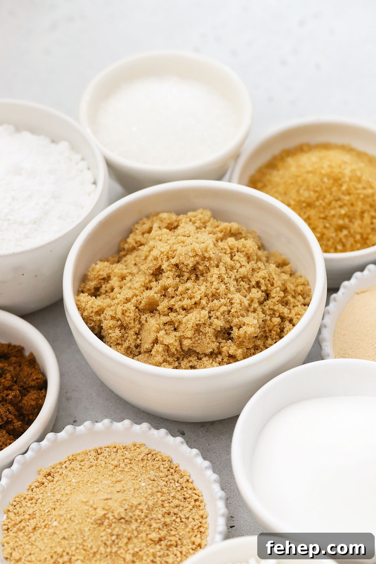 different kinds of sugar in small white bowls